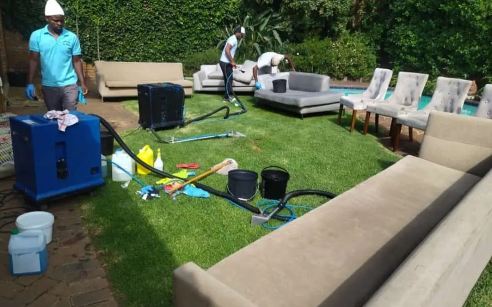Team deep cleaning outdoor furniture on a client’s lawn