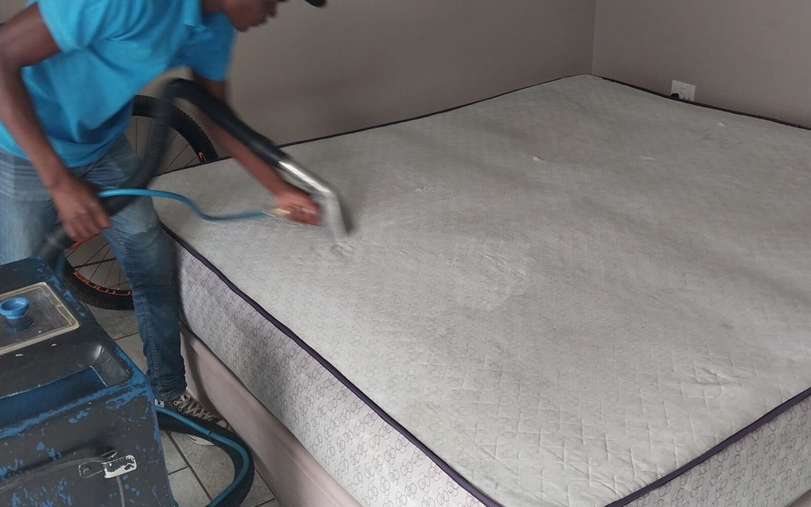 Team member cleaning a carpet in a passage