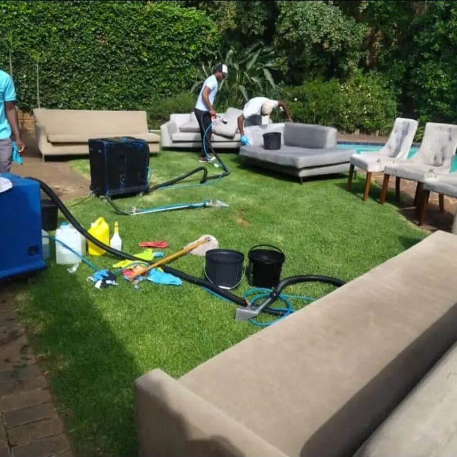 Outdoor couches being deep cleaned on a client’s lawn
