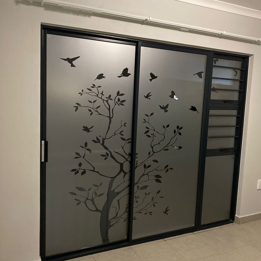Decorative tree and birds frosted door design