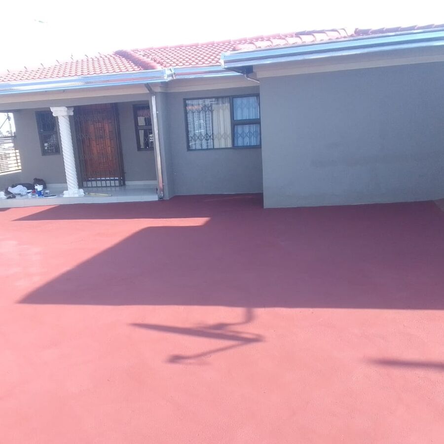 Painted paving and a freshly finished home exterior