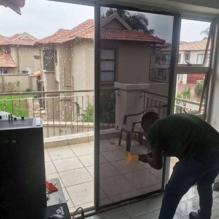 Tint film being fitted to a balcony door